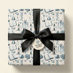 Vintage science wrapping paper with medical illustrations and a black bow, by Wrapped Studios.