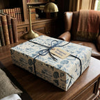Vintage science anatomy wrapping paper on a gift box with a blue ribbon by Wrapped Studios.