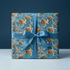 Ocean sea turtle wrapping paper with a blue satin bow on a gift box by Wrapped Studios.