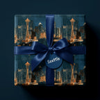 Seattle skyline wrapping paper with a navy blue satin bow and gift tag by Wrapped Studios.
