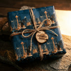 Seattle skyline wrapping paper with a twine bow and Adventure Awaits tag by Wrapped Studios.