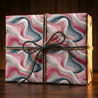 Elegant gift wrapped in modern blush and gray swirl wrapping paper with rustic twine bow.