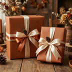 Rust-colored gift wrap with satin ribbons and pinecone accents for rustic holiday present wrapping.