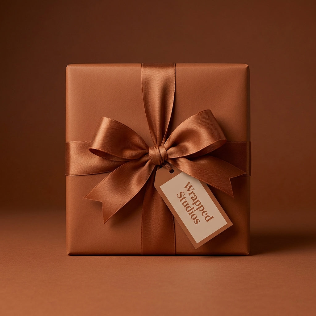 Elegant gift wrapped in solid copper wrapping paper with a satin ribbon bow, perfect for any occasion.