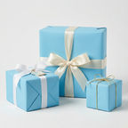 Light blue gift boxes wrapped in solid color paper with ivory and gold ribbon, elegant present wrapping.
