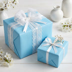 Light blue wrapping paper with white lace ribbon for baby shower, birthday, or elegant gift wrapping.