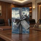 Elegant "Welcome Home" gift wrapped in scenic Seattle skyline wrapping paper with a gray satin bow.