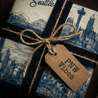 Seattle skyline wrapping paper with PNW vibes gift tag, tied with jute twine and black ribbon.