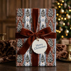 Vintage Christmas wrapping paper with pine tree pattern and brown velvet bow by Wrapped Studios.