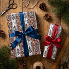 Vintage Christmas tree gift wrap with blue and red ribbons on a rustic wood table by Wrapped Studios.