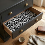 Soccer wrapping paper with a black and white ball pattern lining a dresser drawer, by Wrapped Studios.