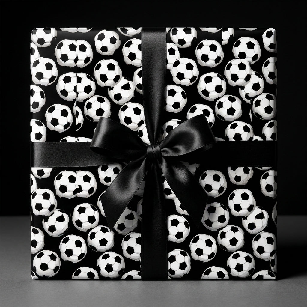 Soccer wrapping paper with a black satin bow on a gift box, sports birthday gift wrap by Wrapped Studios.