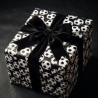 Soccer wrapping paper with a luxury black velvet bow on a birthday gift box by Wrapped Studios.