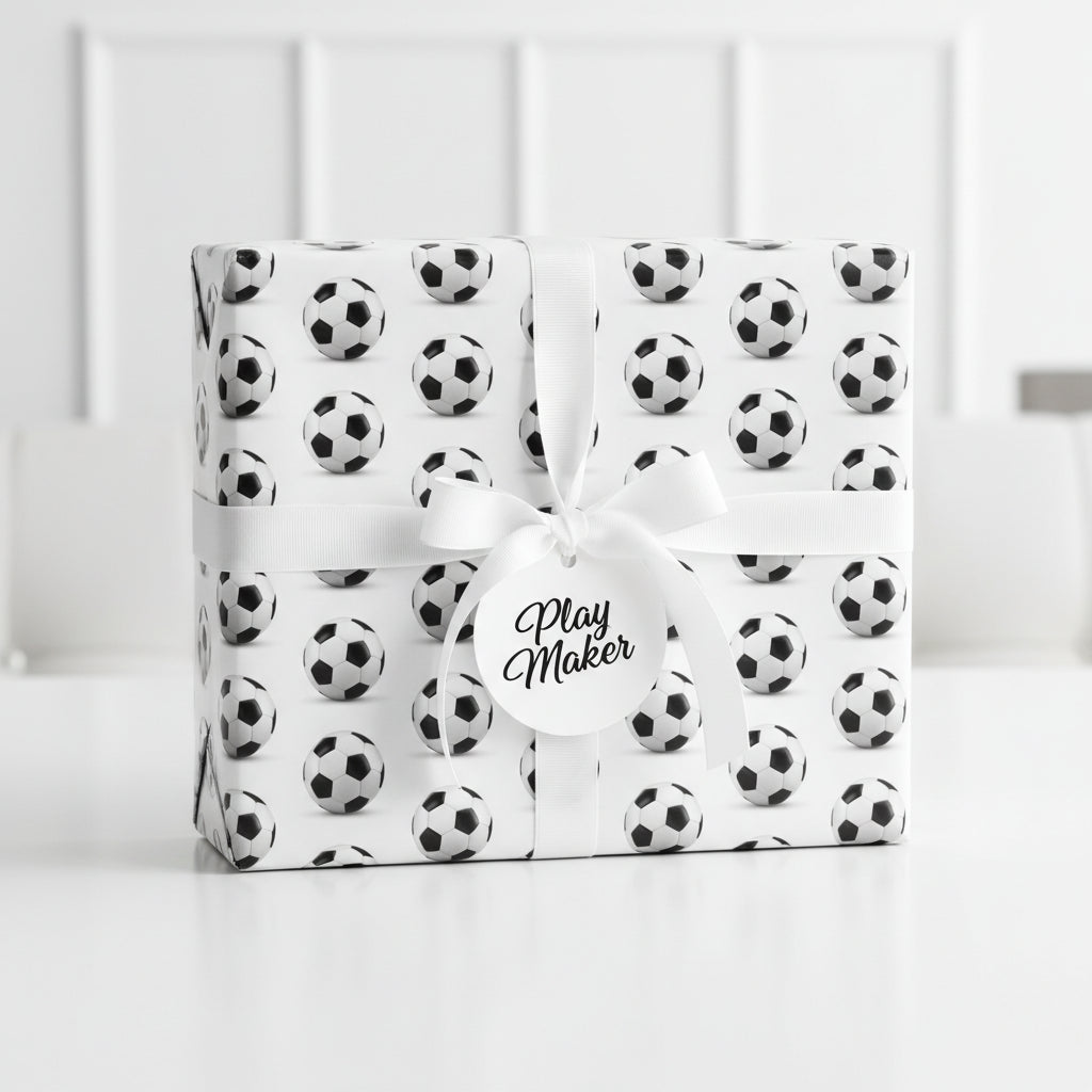 Soccer ball wrapping paper with white ribbon and "Play Maker" tag.