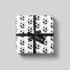 Soccer ball wrapping paper with black ribbon and "Kick Off!" tag.
