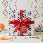 Soccer birthday wrapping paper with red bow. "Happy Birthday, MVP!" gift tag.