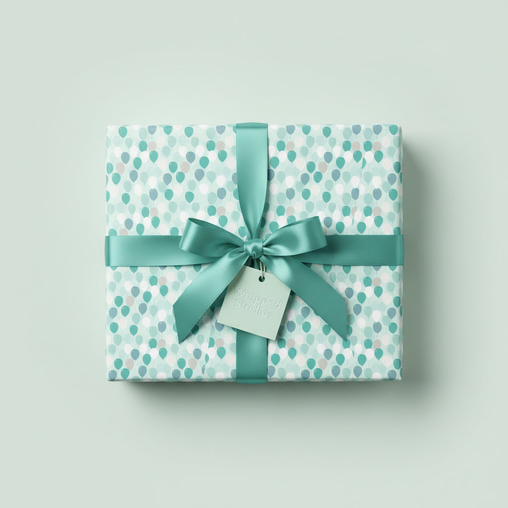 Aqua balloon birthday wrapping paper with satin ribbon and bow on gift box.