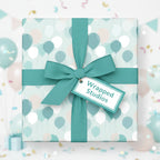 Teal ribbon on a wrapped gift with balloon pattern wrapping paper for birthday presents.