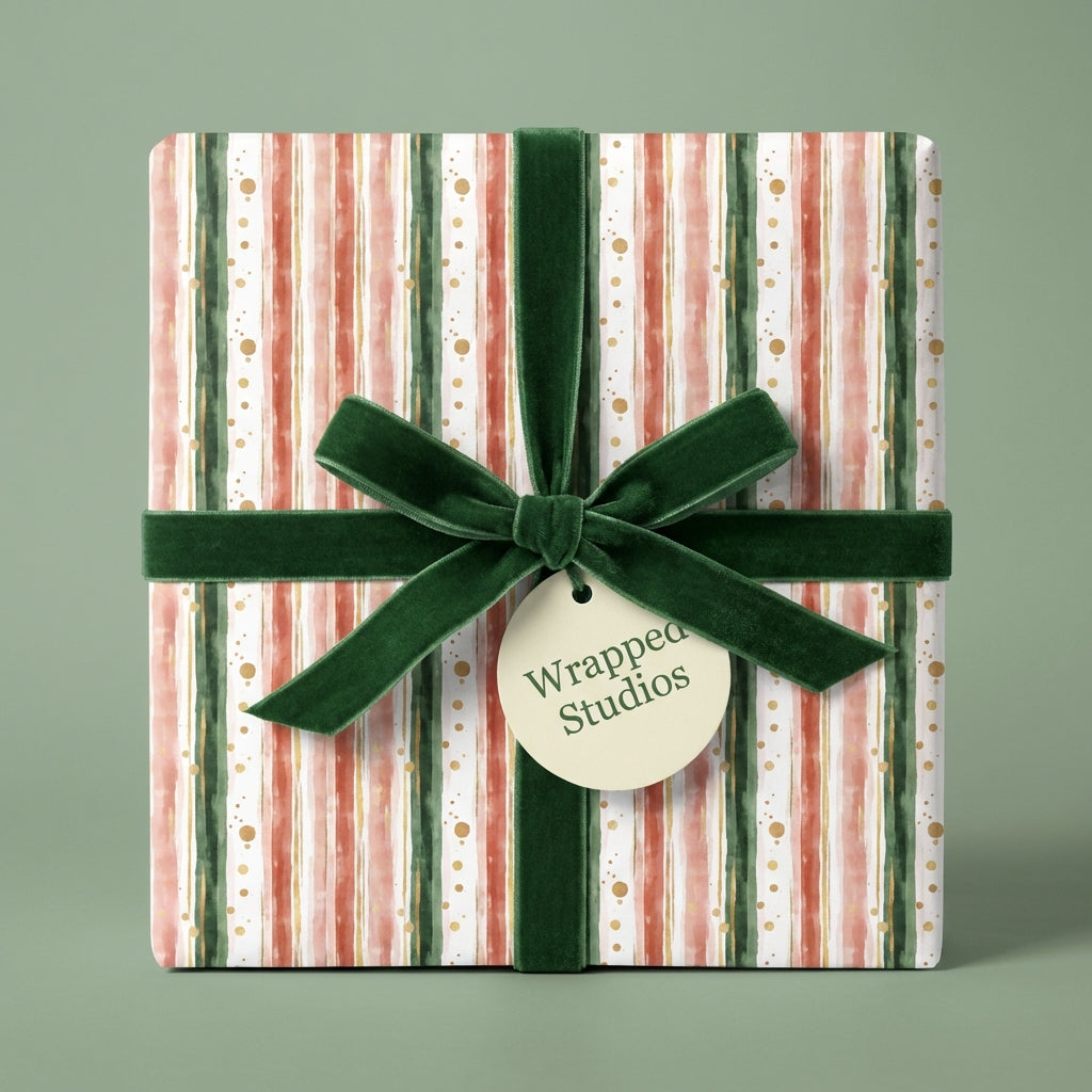 Striped Christmas wrapping paper with a dark green velvet ribbon and gold dots from Wrapped Studios.