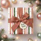 Watercolor stripe Christmas gift wrap with copper ribbon and ornaments.