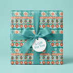Southwest boho gift wrap with turquoise cactus patterns, teal satin ribbon, and gift tag by Wrapped Studios.