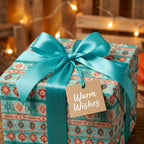Southwestern wrapping paper with a teal satin ribbon and "Warm Wishes" tag by Wrapped Studios.