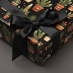 Modern gift box wrapped in cactus-themed wrapping paper with black ribbon.
