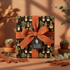 Square gift wrapped in cactus print paper with rust-colored ribbon and "A Little Prickly" tag.
