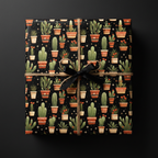 Gift wrapped in black cactus print paper, tied with twine and a black ribbon.
