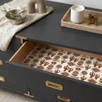 Boho cactus wrapping paper lining a black dresser drawer. Southwest gift wrap by Wrapped Studios.
