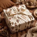 Southwest cactus wrapping paper on a gift box with a cream ribbon and Warm Wishes tag by Wrapped Studios.