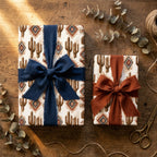 Southwest cactus wrapping paper by Wrapped Studios with rust and navy chiffon bows on a wooden table.