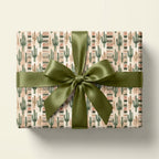 Southwestern cactus wrapping paper on a gift box with olive green satin bow by Wrapped Studios.