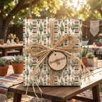 Southwest cactus wrapping paper on a housewarming gift with raffia bow by Wrapped Studios.