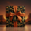 Square gift wrapped in elegant desert cactus wrapping paper with an orange satin ribbon and bow.