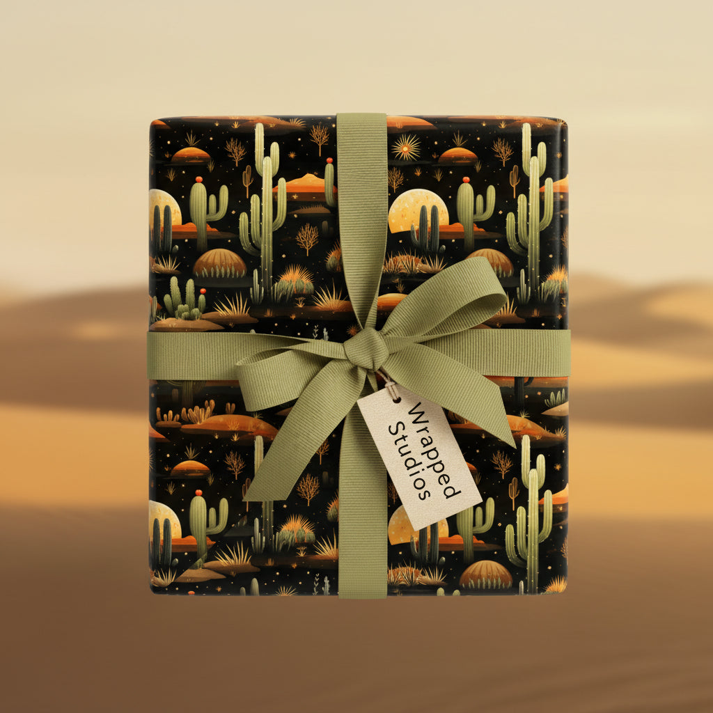 Square gift wrapped in desert-themed wrapping paper with cacti and a sage green ribbon.