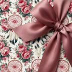 Vintage floral wrapping paper with dreamcatchers and a dusty rose satin bow by Wrapped Studios.