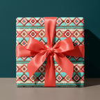 Boho southwest wrapping paper with teal Aztec pattern and coral satin bow, by Wrapped Studios.