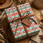 Southwestern wrapping paper with teal and coral Aztec print on a rustic gift box by Wrapped Studios.