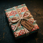 Teal and rust southwestern wrapping paper with twine and Welcome Home tag by Wrapped Studios.