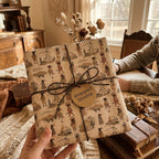 Rustic vintage wrapping paper with illustrated native motifs and a twine bow by Wrapped Studios.