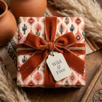 Southwestern wrapping paper with cactus pattern and terracotta velvet bow by Wrapped Studios.