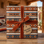 Southwestern wrapping paper with tribal print, rust velvet bow, and adventure gift tag by Wrapped Studios.