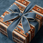 Rustic southwestern wrapping paper in orange and blue with a fabric bow by Wrapped Studios.