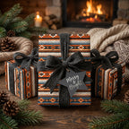 Rustic Southwest Christmas wrapping paper by Wrapped Studios with an orange Aztec pattern and black yarn bow.
