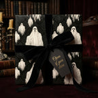 Spooky ghost Halloween wrapping paper with a black velvet bow and gothic gift tag by Wrapped Studios.