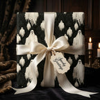 Spooky ghost Halloween wrapping paper with a cream satin bow by Wrapped Studios.