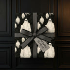 Spooky ghost Halloween wrapping paper with a grey bow, gothic luxury gift wrap by Wrapped Studios.