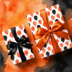 Halloween balloon wrapping paper with orange and black satin bows by Wrapped Studios.