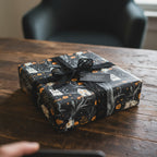 Stylish Halloween gift wrap: Black wrapping paper with pumpkins, haunted houses, and black lace ribbon.